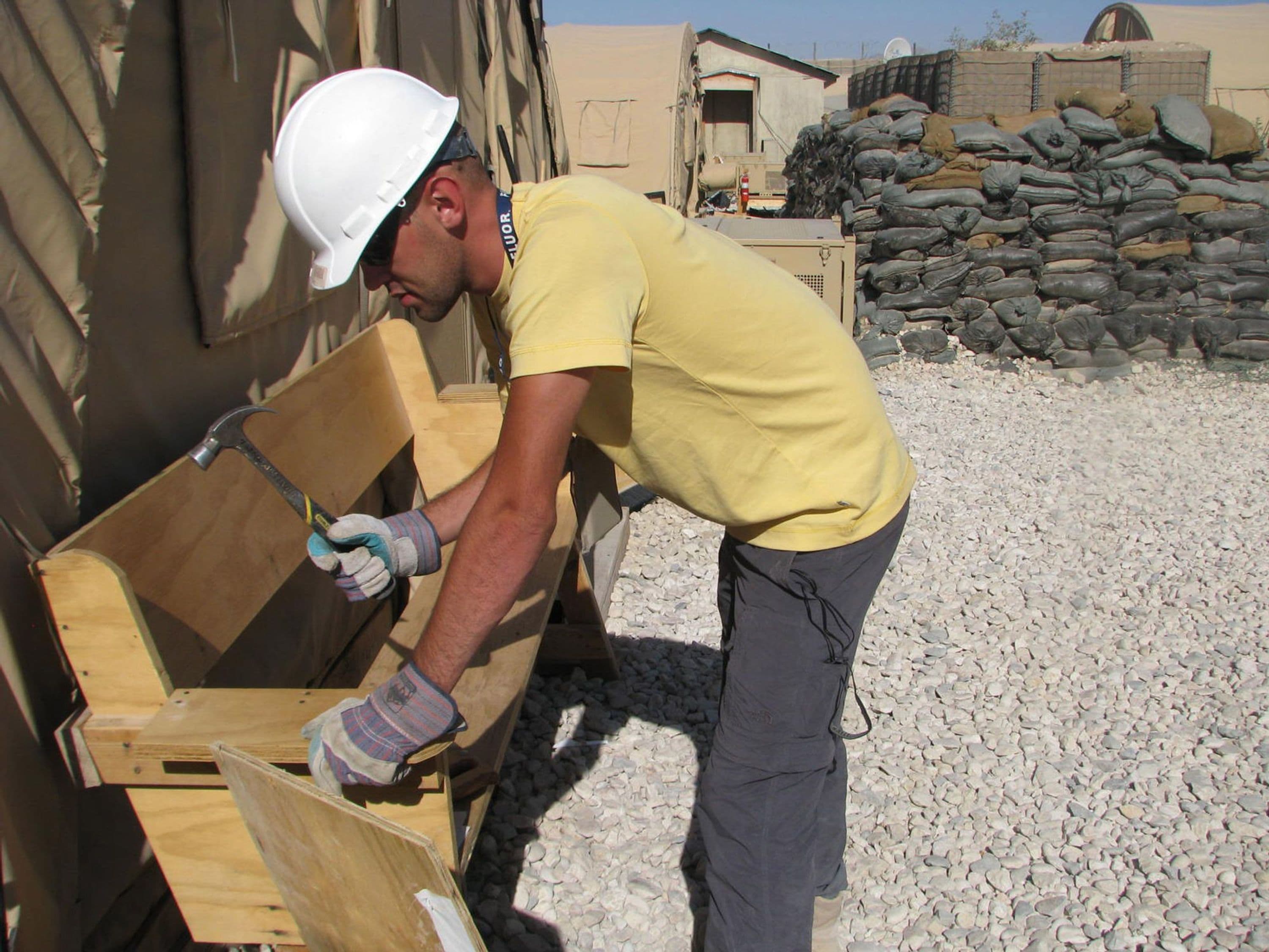 Fluor worker building a bench at Forward Operating Base Maymenah