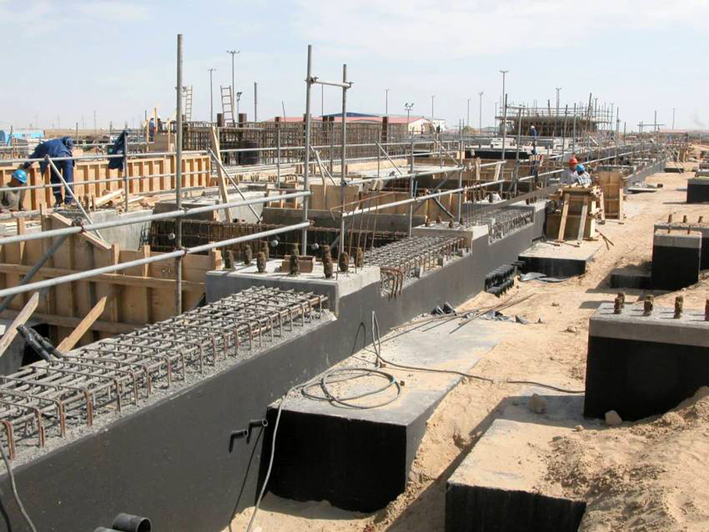 Construction workers building gas turbine hall foundations