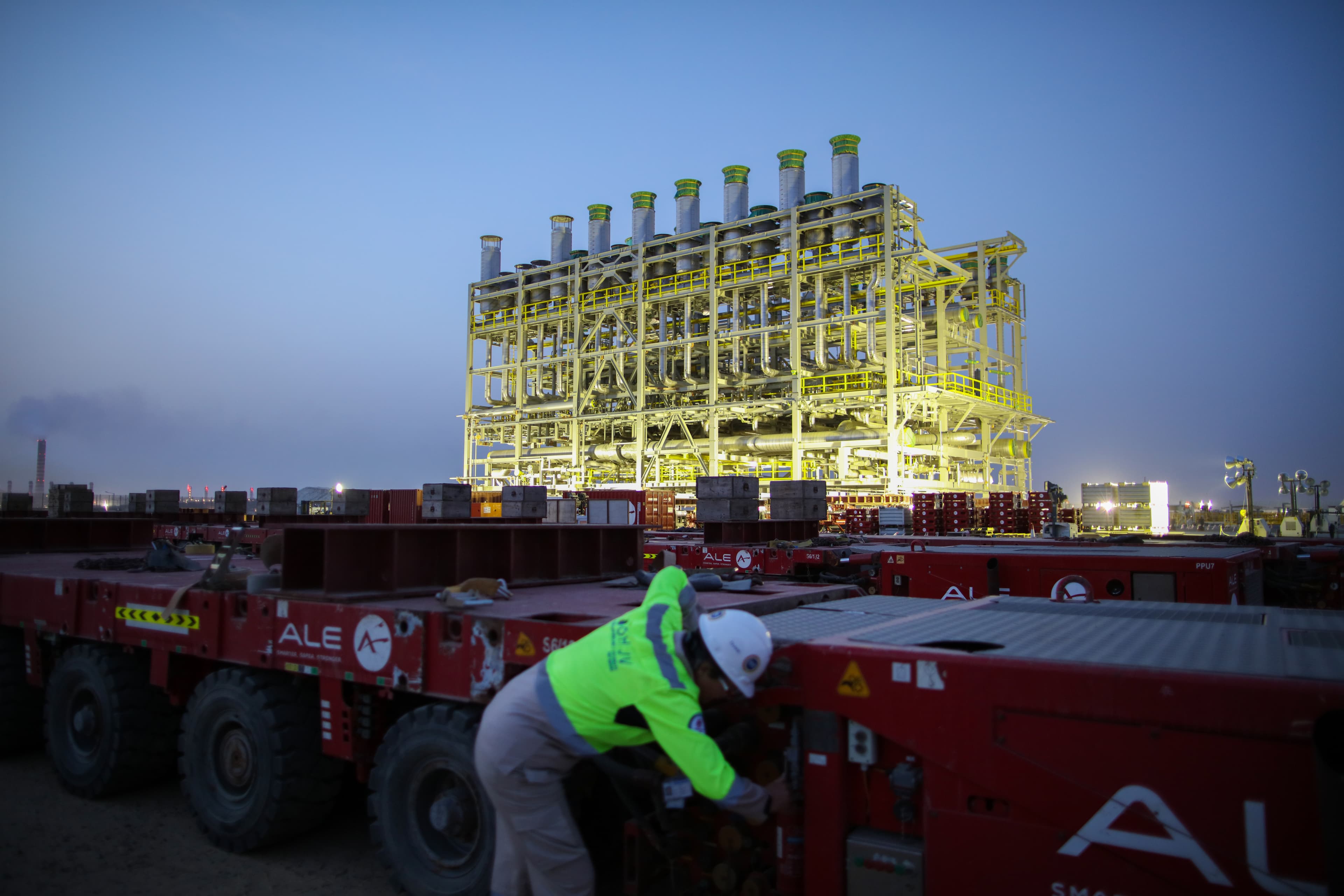 KIPIC project site with worker in the foreground and module in the background